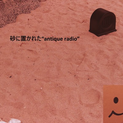 "Antique radio" placed in the sand Front Cover